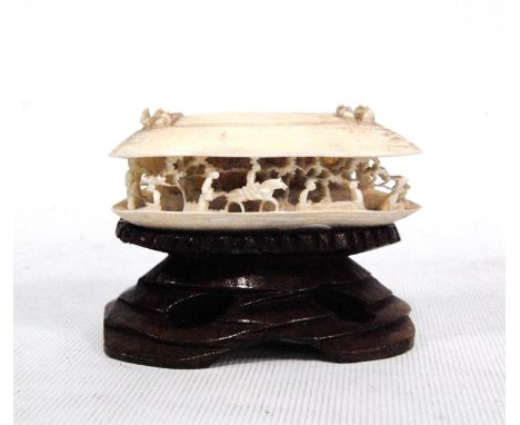 19th century ivory netsuke of a mussel shell partly open revealing a village scene, 7cm wide. 