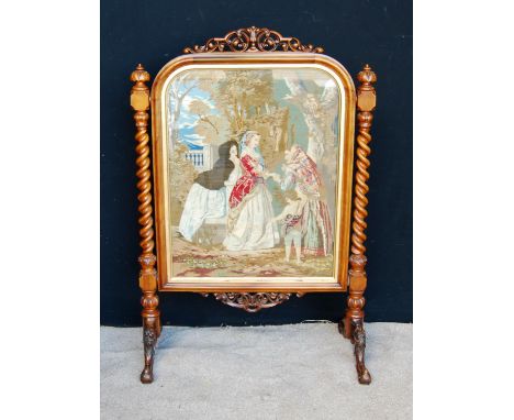 Victorian walnut framed firescreen mounted by pierced scroll work, moulded rounded rectangular frame enclosing needlepoint, r