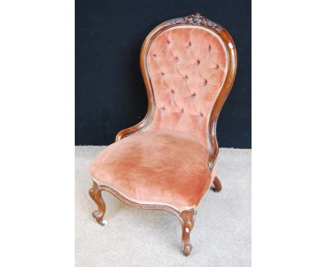 Victorian button-back lady's chair with serpentine cushioned seat and raised on cabriole legs terminating in ceramic castors,