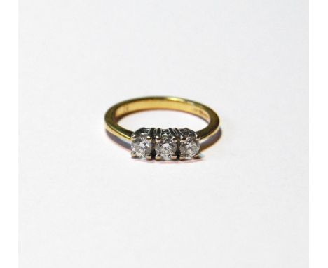 Diamond three-stone ring, brilliants totalling '.5', in 18ct gold, size K. 