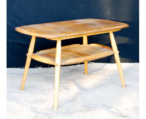 Ercol coffee table with rounded rectangular top, pierced handles, raised on splayed turned legs united by a shelf, 72cm wide,