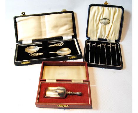 Set of six silver cocktail sticks, a pair of jam spoons and a shovel caddy or sugar spoon, all cased. 