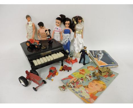 A box of Meccano, a collection of 1980s and later figures, Barbies and Kens, a Pixland? toy piano, a die cast tractor, etc