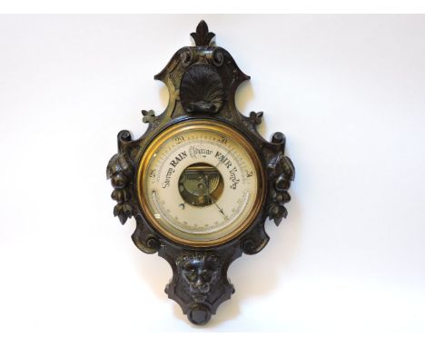 A Victorian oak aneroid barometer/thermometer, with a lion mask, 60cm high