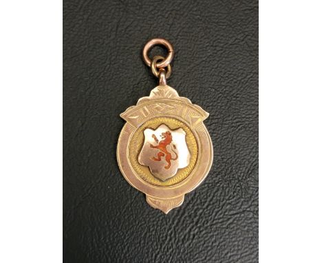 NINE CARAT GOLD SPORTING MEDAL FOBthe front with red enamel lion rampant, the reverse engraved 'T.A.S.C Allan Cup. Won by R D