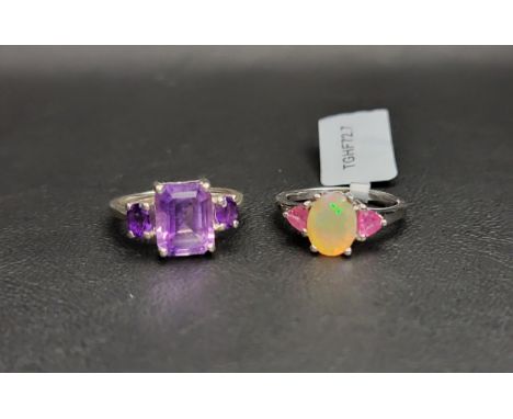 TWO GEM SET RINGS AND MATCHED PAIRS OF EARRINGScomprising an amethyst three stone ring together with a pair of pear cut ameth