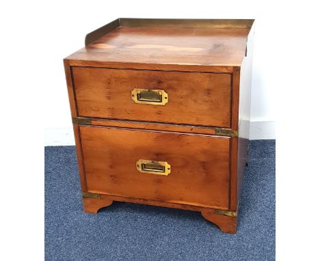 YEW BEDSIDE CHESTwith a brass three quarter galleried top above two drawers with flush fitting brass handles, standing on bra