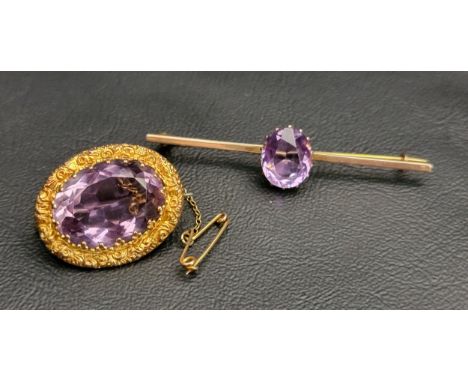 TWO AMETHYST SET NINE CARAT GOLD BROOCHES one with large central oval cut amethyst measuring approximately 20.8mm x 14.7mm x 