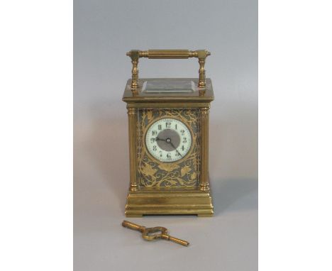 Large French gilt brass carriage clock with Arabic ceramic dial set in a pierced foliate frame work. Two train movement. Stri