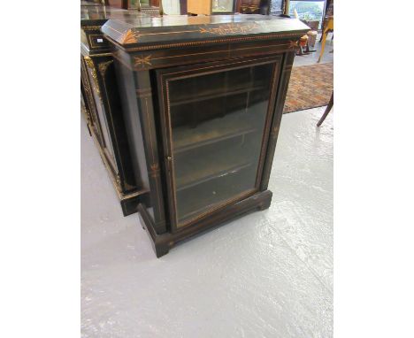 Victorian ebonised and inlaid pier cabinet, the moulded and shaped top above a single glazed door, the interior revealing fit