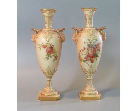 Pair of Royal Worcester blush ivory 1410 hand painted vases of oval form having classical flared neck, mask head handles, and