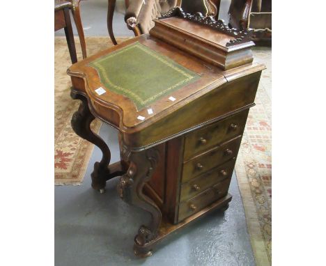 Victorian walnut Davenport desk of serpentine form having shaped moulded supports with four drawers on ceramic castors.(B.P. 