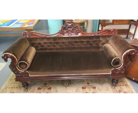 Victorian walnut show frame, double ended sofa, the carved scroll decorated back above padded button-back upholstery flanked 