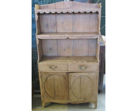 19th century pine farmhouse kitchen cabinet, the shaped top above a shaped frieze with fitted shelf, the projecting base with