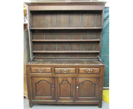 Early 19th century Welsh oak dresser with boarded three shelf rack back having moulded cornice, the base with three moulded d