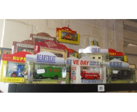 Shelf of over 20 Lledo diecast vehicles, inc. 'Rupert', 'Heartbeat' and 'Coronation Street'