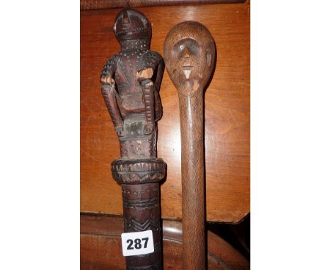 Tribal Art: African hardwood walking stick with carved head handle and glass eye and another African walking stick with carve