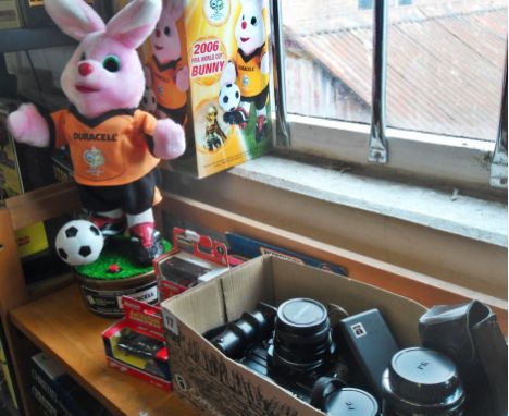 Chinon CE-5 camera, three various lenses, a Kodak Ektra camera and a Duracell 2006 World Cup "Bunny" automaton