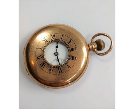 A Dennison watch Co. 9ct gold half hunter. Birmingham 1922. The 40mm white enamel dial with Roman numerals and seconds subsid