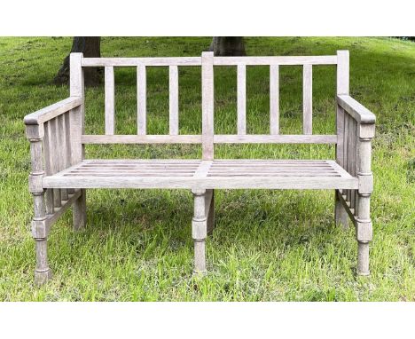 GARDEN BENCH, weathered teak slatted with finely turned and stretchered front supports, 125cm W. 