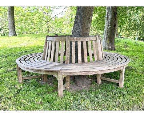 GARDEN TREE BENCH, weathered teak in two sections, with slatted upstand and concentric slatted seat, 220cm W (100cm inner wid