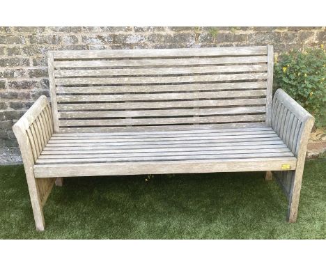 GARDEN BENCH, weathered teak with horizontal slat back and seat and downswept arms by 'Trinity', 162cm W. 