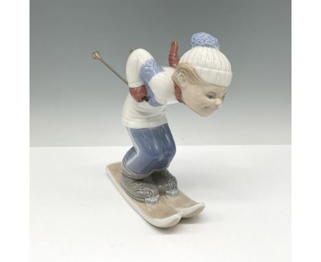 Glossy downhill skier figural colored in light blue, gray and white. Lladro backstamp. Artist: Juan HuertaIssued: 1977 - 1985
