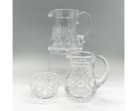Two clear crystal pitchers and small bowl in a criss cross and leaf pattern. Royal Doulton mark. The larger pitcher is 7"L x 
