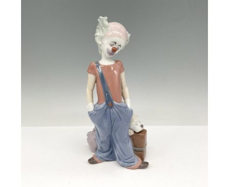 1996 Event Figurine. Glossy sad figural standing with luggage and his dog. This item has its original box: 5.5"L x 11"W x 5"H