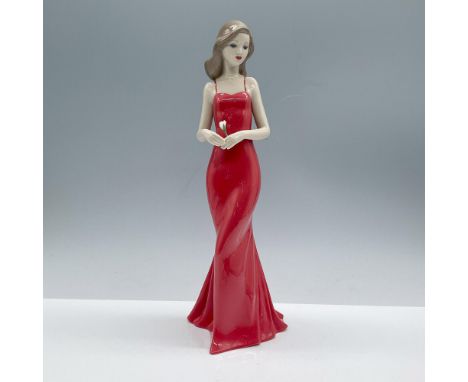 Beautiful glossy porcelain figure of a woman in a long smooth red dress, holding a white rose standing on a calm elegant pose