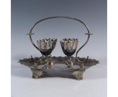 The footed caddy tray with basket handle has silverplate maker hallmarks on the bottom and measures 8.5"L x 6"W x 6"H. The eg