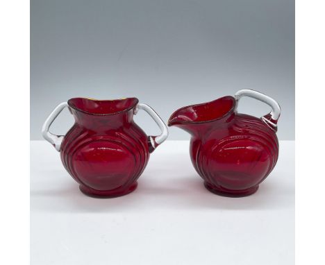 This beautiful crystal duo features a stunning ruby color with clear crystal handles. Issued: 20th centuryDimensions: 2.5''L 