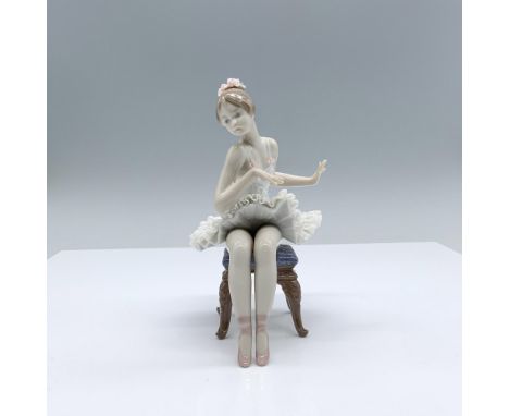 Whether standing or sitting her serenity and strength are shown. The figurine has a glossy finish and Lladro backstamp. This 