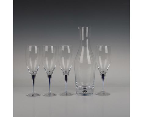 Four wine glasses and one carafe, each adorned with a sophisticated deep blue accent. Orrefors Sweden manufacturing sticker. 