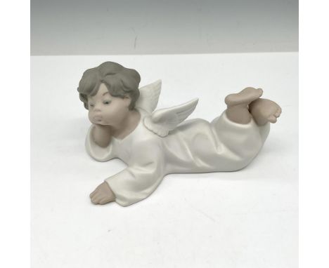 Matte finished figural colored in white, cream and gray. Lladro backstamp. This item has its original box: 8"L x 5"W x 5"H. A