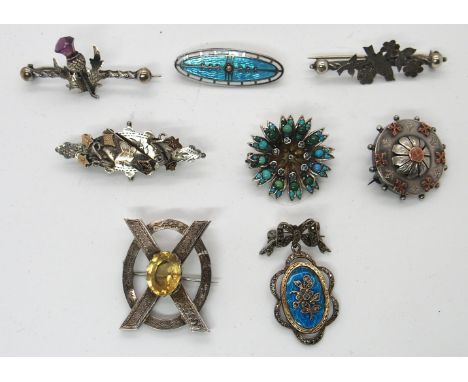 A collection of silver and white metal vintage brooches to include an enamel and marcasite  brooch and one set with turquoise
