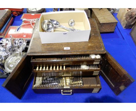 An oak part canteen of EP King's pattern cutlery (102 pieces approximately), with matching soup ladle, two basting spoons and