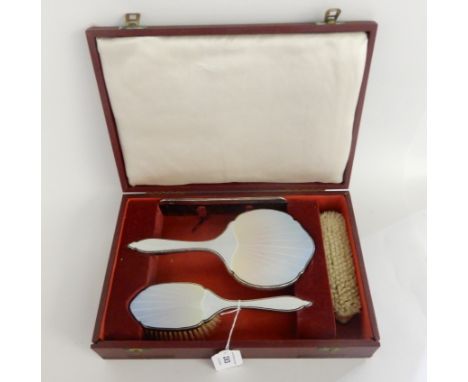 A cased four piece silver and enamel dressing table set, London 1946 Condition Report: Available upon request