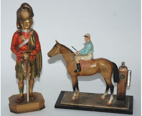 A match striker modelled as a rider and jockey, a table lighter modelled as a highland soldier and small collection of lead f