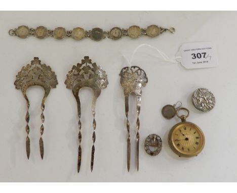 A lot comprising three silver hair combs (assorted marks), an Art Nouveau button, a small buckle, a lady's gilt metal fob wat