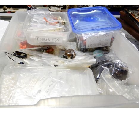A box full of semi precious stones, beads, and costume beads to include coral, carved amethyst frog beads, rose quartz beads,