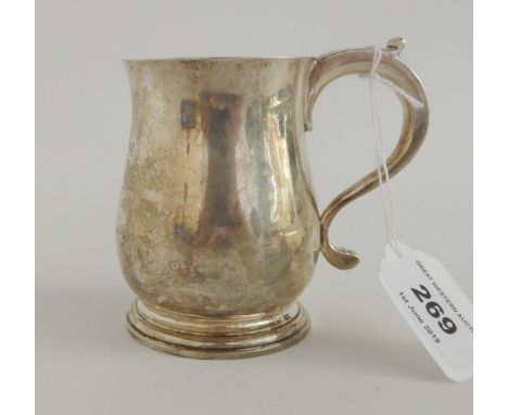 A silver tankard by William Comyns &amp; Sons, London 1927, of baluster form with scrolling handle with thumbpiece, inscribed