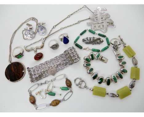 A wide fancy silver bracelet with heart shaped clasp, a silver Chinese symbol brooch made by Tacking of Hong Kong, two malach