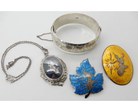 A collection of silver Siam neillo and enamel ware, and a wide silver bangle Condition Report: Available upon request