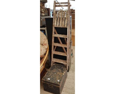 Wooden step ladder along with a tin trunk
