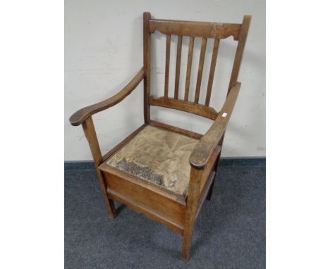 An Edwardian beechwood commode chair.