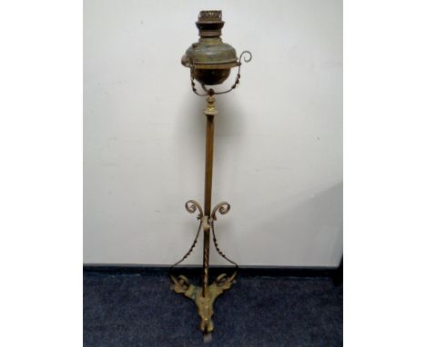 An antique brass rise and fall standard oil lamp 