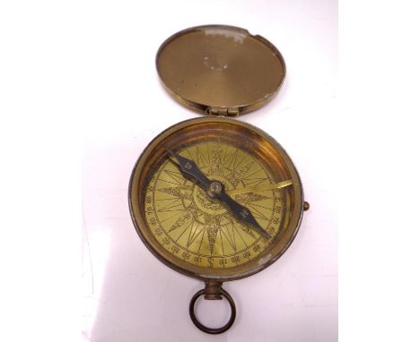 A brass pocket compass.