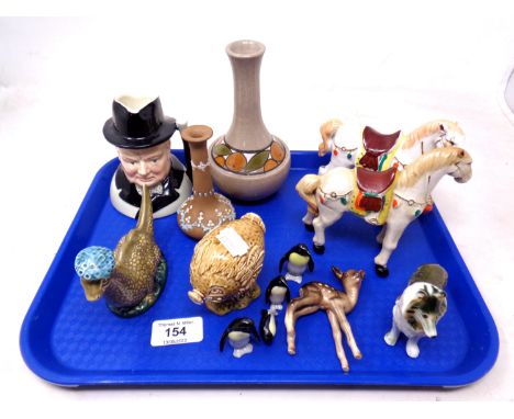 A tray containing Sylvac Winston Churchill jug, Beswick Beneagle's scotch whisky figure of the Loch Ness Monster, further cer