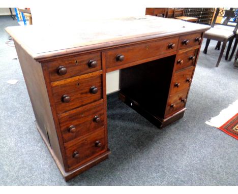 A Victorian mahogany twin pedestal desk fitted with nine drawers and a leather inset panel.